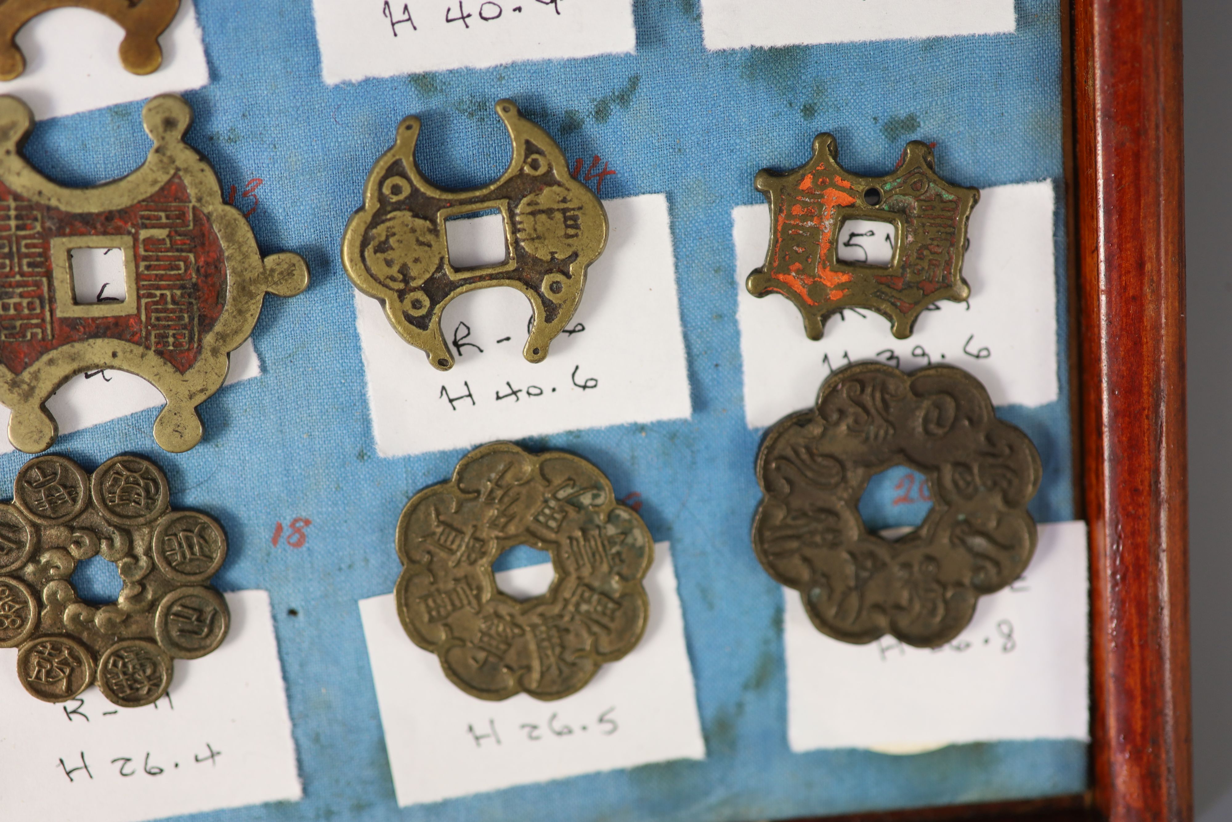 A group of 99 Korean bronze and metal amulets or charms, 19th/20th century